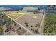 Aerial view of a large land tract featuring mixed terrain and road access at 525 Sanctuary Trl, Cameron, NC 28326