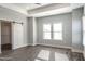 Bright bedroom featuring tray ceiling, barn door, and wood-look flooring at 525 Sanctuary Trl, Cameron, NC 28326