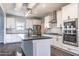 Modern kitchen with white cabinets, stainless steel appliances, and a gray center island at 525 Sanctuary Trl, Cameron, NC 28326