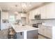 Bright and modern kitchen with large island, white cabinets, and stainless steel appliances at 525 Sanctuary Trl, Cameron, NC 28326