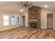 Spacious living room showcasing a stone fireplace and natural light from large windows at 525 Sanctuary Trl, Cameron, NC 28326