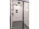 Modern shower featuring gray herringbone tile floor and white subway tile surround at 525 Sanctuary Trl, Cameron, NC 28326