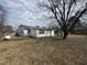Spacious backyard featuring a large shade tree, shed, and play set at 528 Mill St, Smithfield, NC 27577