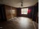 Cozy bedroom featuring hardwood floors, ceiling fan, and a large window at 528 Mill St, Smithfield, NC 27577