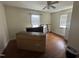 Bedroom features hardwood floors, ceiling fan, and natural light from two windows at 528 Mill St, Smithfield, NC 27577
