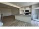Bright, open kitchen with white cabinets, stainless appliances, and view to living area at 605 Leland Hl Cir, Zebulon, NC 27597