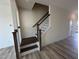 Classic stairway featuring stained wood and white risers provides access to upper level at 605 Leland Hl Cir, Zebulon, NC 27597