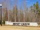 The Sidney Creek community sign welcomes residents with attractive landscaping and stone details at 615 Leland Hl Cir, Zebulon, NC 27597
