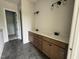 Bathroom featuring double vanity, modern fixtures, and tile flooring at 63 Daybreak Way, Fuquay Varina, NC 27526