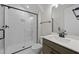 Modern bathroom featuring a glass-enclosed shower, stylish vanity with modern fixtures at 63 Daybreak Way, Fuquay Varina, NC 27526