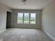 Bedroom with three windows overlooking green space at 63 Daybreak Way, Fuquay Varina, NC 27526