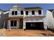 Two-story home construction featuring durable Tyvek HomeWrap and an attached two-car garage at 63 Daybreak Way, Fuquay Varina, NC 27526