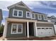 Charming two-story home with board and batten siding, white trim, and a two-car garage at 63 Daybreak Way, Fuquay Varina, NC 27526