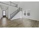 Spacious foyer with staircase and hardwood floors, creating an elegant entrance to the home at 63 Daybreak Way, Fuquay Varina, NC 27526