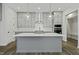 Modern kitchen with gray cabinets, quartz countertops, stainless steel appliances, and pendant lighting at 63 Daybreak Way, Fuquay Varina, NC 27526