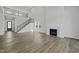 Expansive living room boasts a fireplace, staircase, and elegant design, great for modern living at 63 Daybreak Way, Fuquay Varina, NC 27526