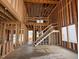 Living room featuring an unfinished staircase at 63 Daybreak Way, Fuquay Varina, NC 27526