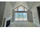 Bright living room with fireplace and large windows offering natural light at 63 Daybreak Way, Fuquay Varina, NC 27526