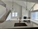 Open living space with kitchen island, fireplace, and staircase at 63 Daybreak Way, Fuquay Varina, NC 27526