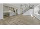 Open-concept living space with view to kitchen and staircase with modern railings, perfect for entertaining at 63 Daybreak Way, Fuquay Varina, NC 27526