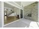 Outdoor patio features a stone fireplace and opens to a spacious living room, seamlessly blending indoor-outdoor living at 63 Daybreak Way, Fuquay Varina, NC 27526