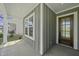 Inviting covered porch with decorative glass door and neutral siding, perfect for relaxing outdoors at 63 Daybreak Way, Fuquay Varina, NC 27526