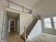 Elegant staircase with wood and iron railing leading to a loft area at 63 Daybreak Way, Fuquay Varina, NC 27526