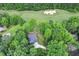 An aerial view of the home surrounded by trees and adjacent to a golf course with sand traps at 632 Angus Ct, Sanford, NC 27332