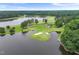 Breathtaking aerial view of a luxury home on golf course with waterfront access and picturesque scenery at 632 Angus Ct, Sanford, NC 27332