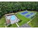 Overhead view of the pool and tennis courts surrounded by lush greenery and a parking lot at 632 Angus Ct, Sanford, NC 27332