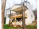 A backyard view of a deck built with sturdy supports and black metal railings, along with a staircase at 632 Angus Ct, Sanford, NC 27332