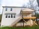 View of the backyard with a deck, staircase, and the house's vinyl siding and window accents at 632 Angus Ct, Sanford, NC 27332