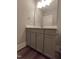 Bathroom vanity with gray cabinet, quartz countertop, large mirror, and modern fixtures at 632 Angus Ct, Sanford, NC 27332