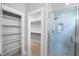 Bathroom featuring a glass enclosed shower with a gray tiled floor and view of the walk-in closet at 632 Angus Ct, Sanford, NC 27332