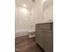 Bathroom with white subway tile and gray vanity and brushed silver fixtures at 632 Angus Ct, Sanford, NC 27332