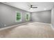 Bright and spacious bedroom with new carpet, two windows, and a ceiling fan at 632 Angus Ct, Sanford, NC 27332