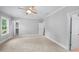 Spacious bedroom featuring neutral walls, plush carpeting, and a modern ceiling fan for added comfort at 632 Angus Ct, Sanford, NC 27332