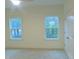 Bright bedroom with neutral carpet, ceiling fan, two large windows offering ample natural light at 632 Angus Ct, Sanford, NC 27332