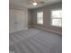 A bedroom with a ceiling fan, windows with wood views, and a large closet at 632 Angus Ct, Sanford, NC 27332