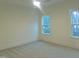 Bright bedroom with neutral carpet, ceiling fan, two large windows offering ample natural light at 632 Angus Ct, Sanford, NC 27332
