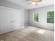 Bedroom with a ceiling fan and carpeted floors illuminated by natural light from two windows at 632 Angus Ct, Sanford, NC 27332
