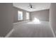 Expansive bedroom with neutral walls and carpet, large windows and a ceiling fan at 632 Angus Ct, Sanford, NC 27332