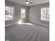 An expansive bedroom features neutral paint, carpet and three large windows at 632 Angus Ct, Sanford, NC 27332