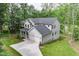 An aerial view of the home showcasing its architectural design, two-car garage, and surrounding greenery at 632 Angus Ct, Sanford, NC 27332
