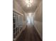 Well-lit hallway features hardwood floors, wainscoting, and decorative lighting fixtures at 632 Angus Ct, Sanford, NC 27332