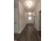 Long hallway with white trim work featuring hardwood floors and decorative lighting fixtures at 632 Angus Ct, Sanford, NC 27332