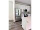 Modern kitchen features stainless steel appliances, white cabinets, light countertops and gray backsplash at 632 Angus Ct, Sanford, NC 27332