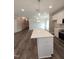 Open concept kitchen with modern white cabinets and large island with white countertop, flowing to dining room at 632 Angus Ct, Sanford, NC 27332