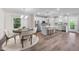 Open-concept kitchen with modern appliances, island seating, and adjacent dining area bathed in natural light at 632 Angus Ct, Sanford, NC 27332