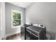 Laundry room featuring modern gray washer and dryer next to a bright window at 632 Angus Ct, Sanford, NC 27332